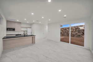 Kitchen featuring sink and light brown cabinets