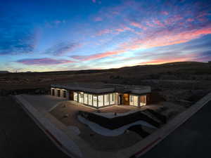 Back house at dusk with a patio