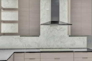 Details with backsplash, stovetop, and wall chimney exhaust hood