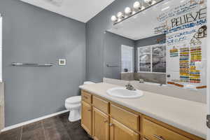 Bathroom with vanity, tile patterned flooring, and toilet