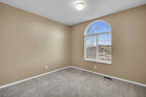 Empty room with light colored carpet