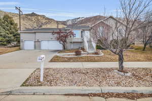 View of front of home with a garage and a mountain view