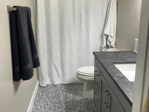 Bathroom with tile patterned floors, vanity, and toilet