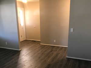 Spare room with dark hardwood / wood-style floors