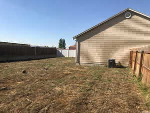 View of side of home with a lawn