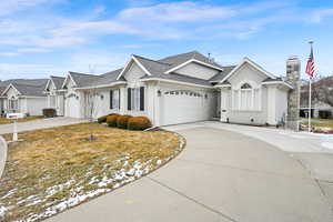 Ranch-style home with a garage and a front lawn