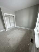 Unfurnished bedroom featuring a closet and a textured ceiling