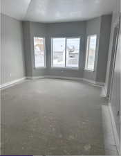 Unfurnished room featuring a textured ceiling