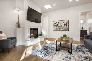 Living room with a skylight and concrete flooring