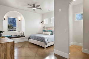 Tiled bedroom featuring ceiling fan