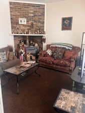 Living room featuring a fireplace and carpet flooring