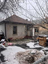 View of snow covered rear of property