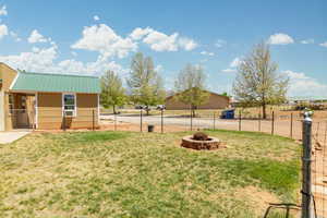 View of yard with an outbuilding and a fire pit