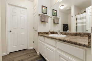 Bathroom featuring vanity and hardwood / wood-style floors