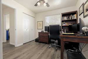 Office space with ceiling fan and light hardwood / wood-style floors