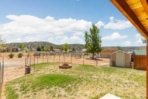 View of yard with a storage unit and a mountain view