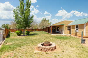 View of yard featuring an outdoor fire pit and a patio