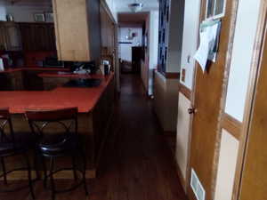 Kitchen with dark hardwood / wood-style floors