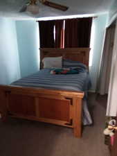 Carpeted bedroom with ceiling fan