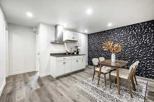 Dining room featuring sink and light hardwood / wood-style floors