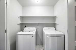 Washroom featuring washer and clothes dryer