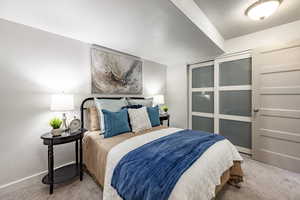 Bedroom featuring light carpet and a textured ceiling