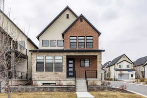 View of front facade with a garage and a front lawn