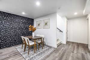 Dining space with light hardwood / wood-style flooring