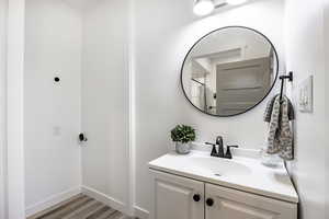 Bathroom with hardwood / wood-style flooring and vanity