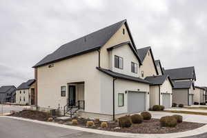 View of home's exterior featuring a garage and central AC unit