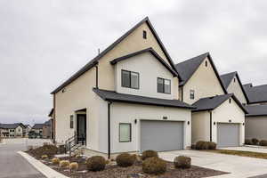 View of front facade featuring a garage