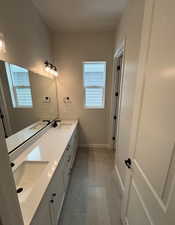 Bathroom with tile patterned flooring and vanity