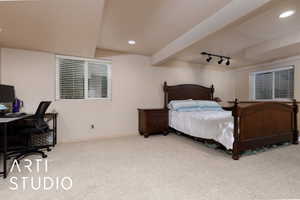 Bedroom featuring track lighting, light colored carpet, and a textured ceiling