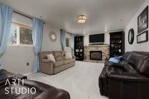 Living room featuring light colored carpet and a brick fireplace