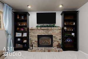 Living room featuring a brick fireplace, carpet, and a textured ceiling