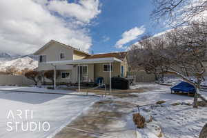 Snow covered house featuring a mountain view