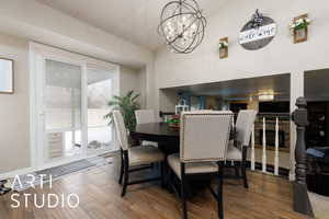 Dining area with an inviting chandelier and hardwood / wood-style floors