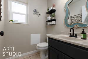 Bathroom featuring tile patterned floors, vanity, and toilet