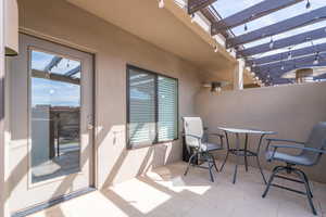 Balcony featuring a pergola