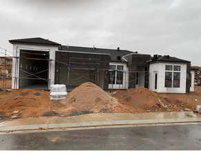 Unfinished property featuring a garage