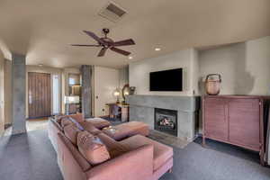 Living room featuring ceiling fan and carpet flooring