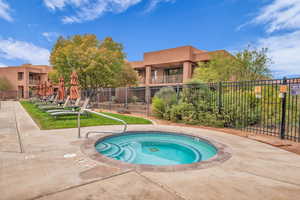 View of swimming pool with a community hot tub