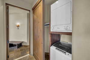 Laundry room with stacked washer and dryer