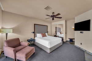 Bedroom with ceiling fan and a closet