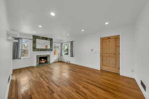 Unfurnished living room with hardwood / wood-style floors and a high end fireplace