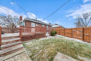 Exterior space featuring a wooden deck and a lawn