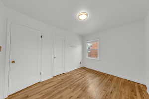 Unfurnished bedroom featuring light hardwood / wood-style flooring and a closet