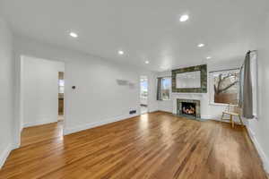 Unfurnished living room featuring a fireplace and light hardwood / wood-style flooring