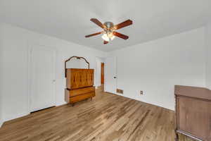 Unfurnished bedroom featuring ceiling fan and light wood-type flooring