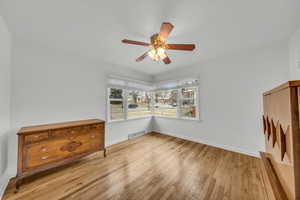 Interior space with ceiling fan and light hardwood / wood-style floors